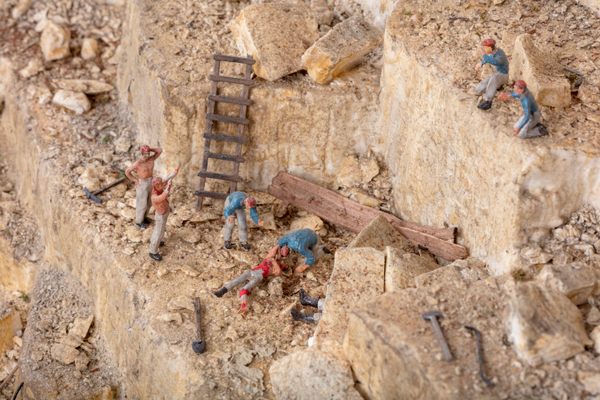 Laborers cluster around an accident at the quarry.